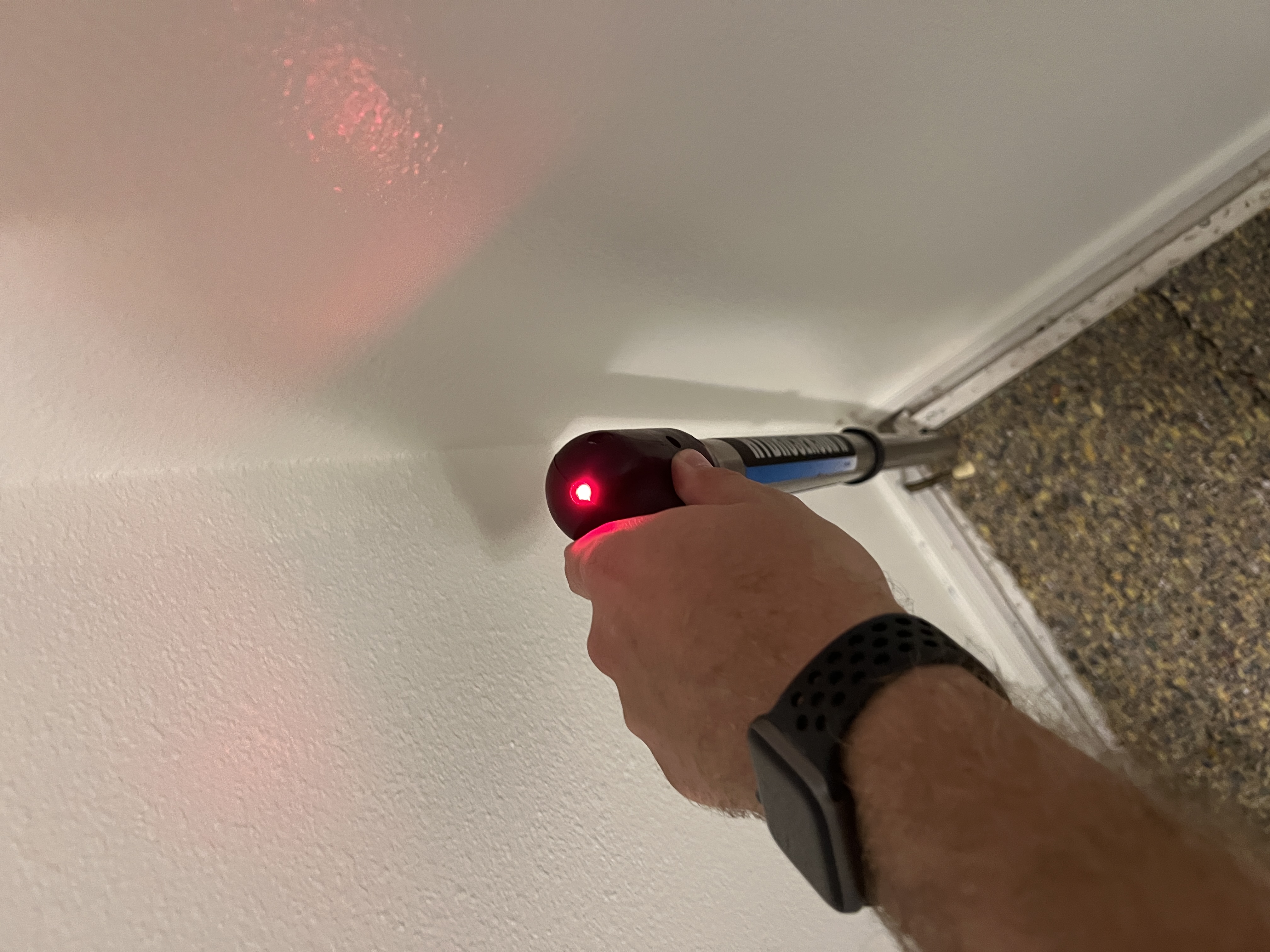A thermal camera in use on an interior wall during a Peak moisture inspection