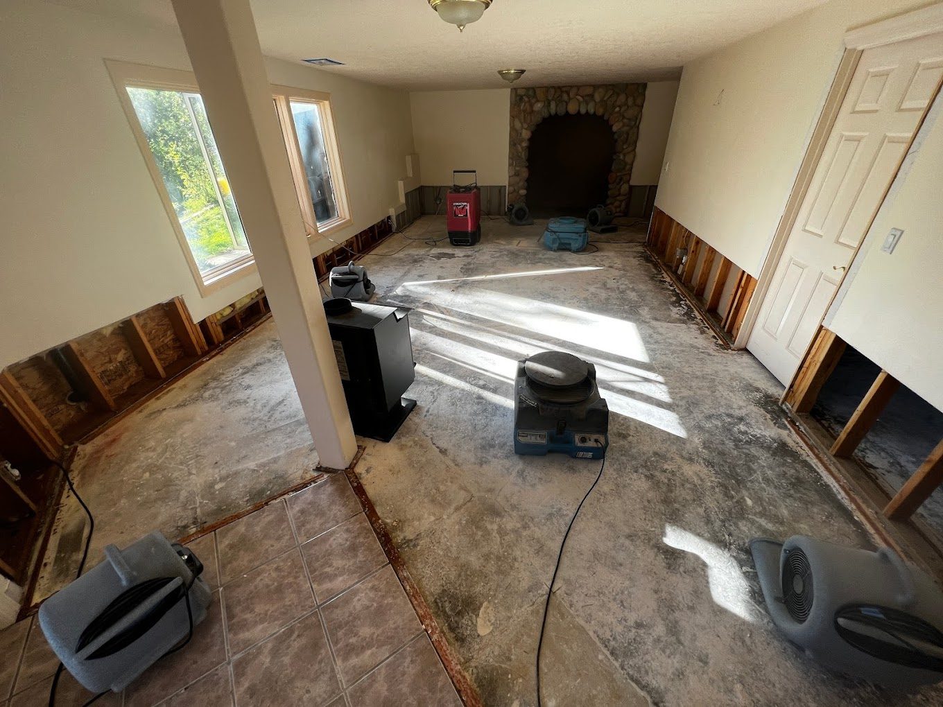 Air movers and dehumidification equipment set in a room on a Peak structural drying job