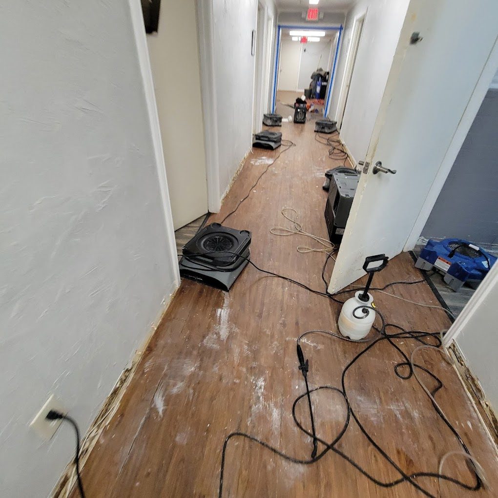 Air movers running in a hallway on a Peak structural drying job