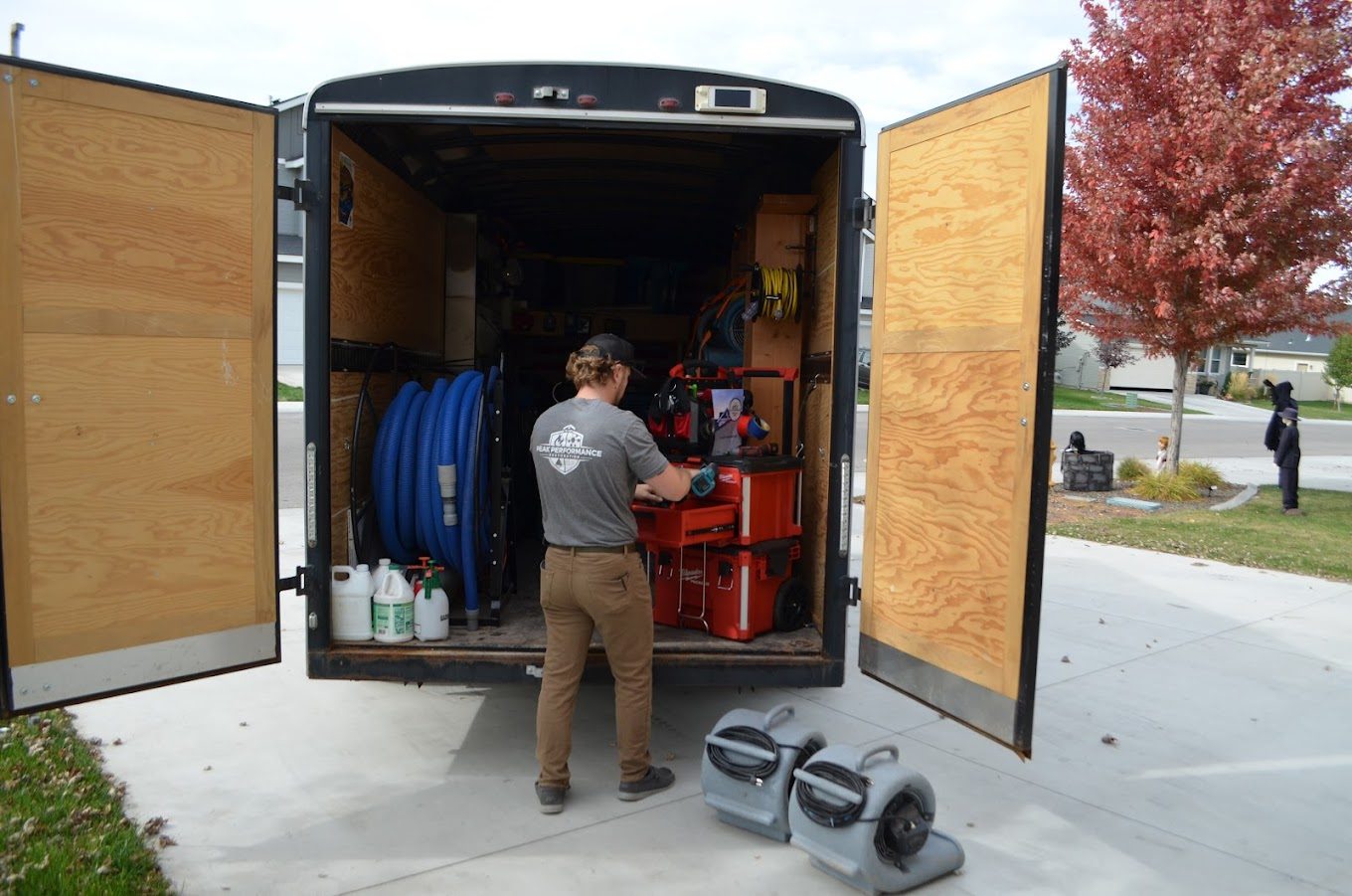 Peak Performance Restoration crew loading drying equipment out of the trailer