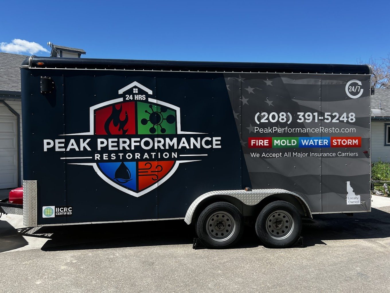 Peak Performance Restoration's branded trailer on a Treasure Valley job
